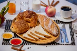 a plate of bread and pastries on a table at Blanc Smith Residence in Siem Reap