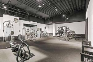 a gym with cardio equipment in a large room at One Bedroom with Roof Top Pool in Sydney