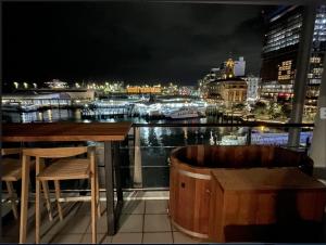 a bar with a view of a city at night at Luxury Apartment - Parking - Hot Tub - Stunning Views in Auckland