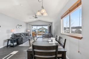 a dining room and living room with a table and chairs at Centrally Located- 4BR Home- Amenities Galore in Spokane Valley