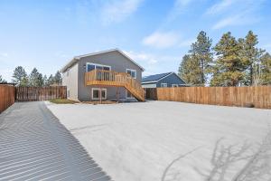 a house with a deck on top of a driveway at Centrally Located- 4BR Home- Amenities Galore in Spokane Valley