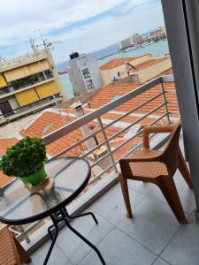 a table and a chair on a balcony at Center City Apt in Chios