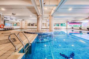 a large pool with blue water in a building at AP Premier Batam in Nagoya