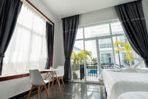 a bedroom with a bed and a large window at Koh Dach View Boutique Hotel in Phnom Penh