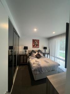 a bedroom with a bed and a large window at Ruckers Hill Northcote Penthouse in Melbourne