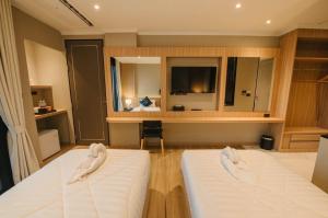 Postel nebo postele na pokoji v ubytování Carrara Hotel Hatyai