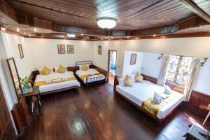 a large room with two beds in it at Dear Villa House in Luang Prabang