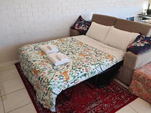 a bed with a blanket on top of a couch at Tuggeranong Short Stay #07C - Sleeps 6 in Canberra