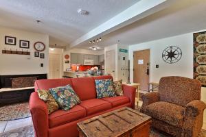 a living room with a red couch and a table at Mountain Green Condo 3A10 condo in Killington