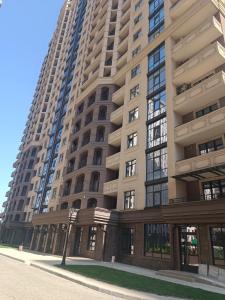 a tall apartment building with a street light in front of it at Сдам квартиру у моря Элегия парк Аркадия in Odesa