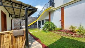 a view of a house with a fence and a staircase at Pool Villa Saung Suluh in Purwokerto