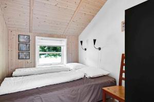 sypialnia z 2 łóżkami w pokoju z oknem w obiekcie Sommerhus I Brunshuse w mieście Hårby