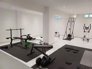 a room with a gym with weights and machines at Deluxe City in Chania