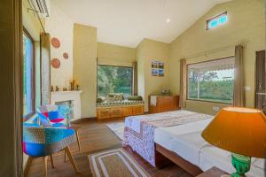 a large bedroom with a bed and a fireplace at SaffronStays Dalewal Jungle Lodge, Hoshiarpur in Hoshiārpur
