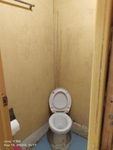 a bathroom with a white toilet in a stall at Shirley's Cottage - Pamilacan Island in Baclayon