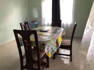 a dining room table with a table cloth on it at Fort Marigold Hotel in Fort Portal