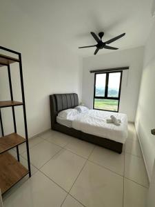 a bedroom with a bed and a ceiling fan at Ipoh Horizon Infinity Pool Suites by Verve in Ipoh