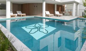 a swimming pool with a butterfly painted on it at Coolum Luxe Apt First Bay 122 in Coolum Beach