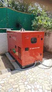an orange machine is sitting on the ground at Paradise corner in Puducherry