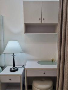 a desk with a lamp and a table with a chair at Chic Studio 5 min walk to Cebu Business Park/Ayala in Cebu City