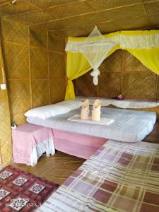 a small room with a bed in a tent at Shirley's Cottage - Pamilacan Island in Baclayon