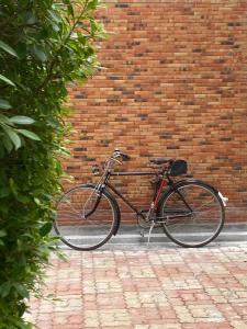 a bike parked in front of a brick wall at Rivera 105 Vacation Home in Kathun