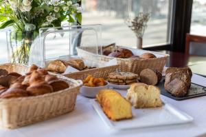 a table topped with baskets of bread and pastries at le paris brest hotel in Rennes +36 photos