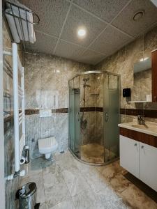 a bathroom with a shower and a sink at Punta Vista Otel in Izmir