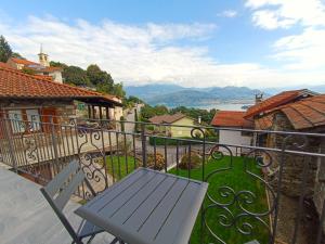 een balkon met een tafel en uitzicht op het water bij Cà di Cambret with lake View in Stresa