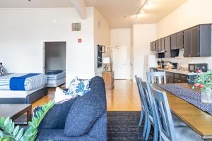 a living room and kitchen with a couch and a table at Greely Gaslamp - Loft W Parking & 4 Beds #401 in San Diego