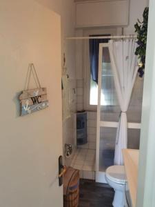 a small bathroom with a toilet and a window at La piccola oasi tra sole e mare in Ceriale +22 photos