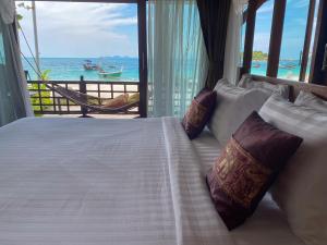 a bedroom with a bed with a view of the ocean at Lipe Beach Resort in Ko Lipe