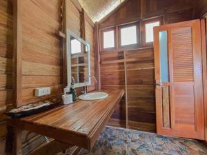 a bathroom with a wooden counter with a sink at Lipe Beach Resort in Ko Lipe