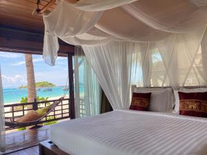 a bedroom with a bed with a view of the ocean at Lipe Beach Resort in Ko Lipe