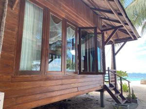 a wooden house on the beach near the ocean at Lipe Beach Resort in Ko Lipe