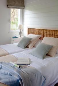 a bedroom with two beds with a laptop on it at Casa de cuento en la playa de Oyambre, al lado de Comillas in San Vicente de la Barquera