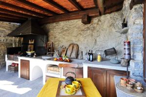 a kitchen with a stove and a table in a room at La Torre Di Porlezza in Porlezza