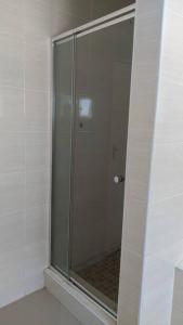 a shower with a glass door in a bathroom at Holiday Haven in Gaborone