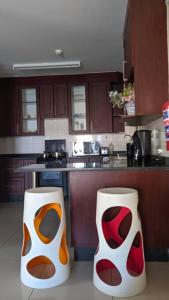 a kitchen with two vases in the middle of it at Holiday Haven in Gaborone