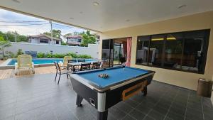 a pool table in the middle of a house at Rumah Amaan in Kuah