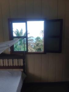 a room with a window and a bed in a room at Casa Mãe - Inn in Principe