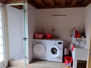 a laundry room with a washer and a washing machine at Gîte Gilles in Le Palais