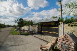 a building with a bench next to a fence at Rezo's Ranch in Samtredia