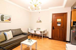 a living room with a couch and a table at Cottonwood Japandi Apartment at Majesty 509 in Bandung