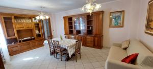 a living room with a table and a couch at Casa Rosa in Teolo