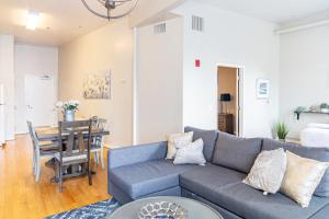 a living room with a blue couch and a table at Greely Gaslamp - Loft W Parking & 3 Beds #402 in San Diego