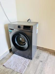 a washing machine sitting in the corner of a room at Apartment unit- Urban chills in Bulindo