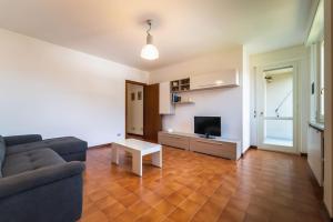 a living room with a couch and a table at Casa Magnodeno in Lecco