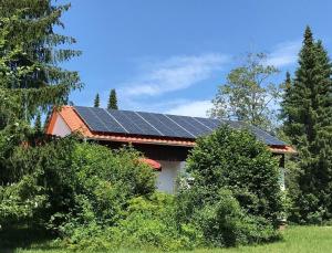 a house with solar panels on top of it at Feriendorf Reichenbach - Dachspfad 5 in Nesselwang