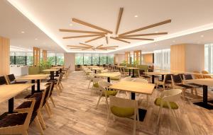 a restaurant with wooden tables and chairs and a large ceiling at Hotel Emion Sapporo in Sapporo